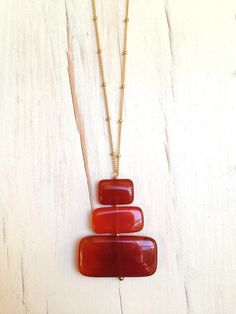 Slabs of vibrant carnelian are wire wrapped to create this contemporary pendant necklace. Pendant hangs from a 14k gold filled beaded chain, select from two length's 18 inches and 22 inches.Pendant size is 1 3/4 inchesMaterials: Carnelian 14k gold filled,Chain ClaspOnly 1 available Dainty Jewelry Rings, Dainty Jewelry Bracelets, Dainty Jewelry Silver, Dainty Fine Jewelry, Dainty Jewelry Necklace, Pearl Bar Necklace, Chrysoprase Necklace, Dainty Gold Jewelry, Contemporary Necklace