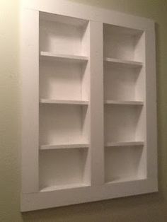 two white bookshelves mounted to the wall