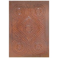 a square metal plate with holes in the middle and an intricate design on it's surface