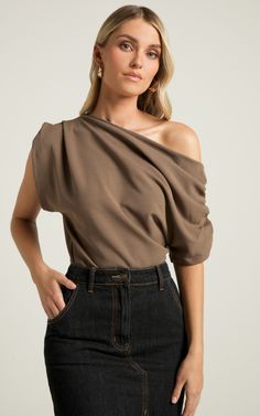 Level up your top collection with the Nalfie Top in Mocha. This asymmetrical beauty is perfect for any occasion, whether it's a party or a day at the office. Crafted from high-quality polyester, this stylish piece will keep you comfortable all day long. The mocha brown hue adds a touch of sophistication to your outfit, while the asymmetrical design brings an edgy twist. Pair it with jeans and heels for a night out or dress it down with pants and flats for a chic workwear look. No matter how you Chic Workwear, Mocha Brown, Going Out Tops, Asymmetrical Tops, Asymmetrical Design, Boat Neckline, Top Collection, Business Outfits, Level Up