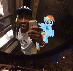 a man taking a selfie in front of a mirror with a pony on it