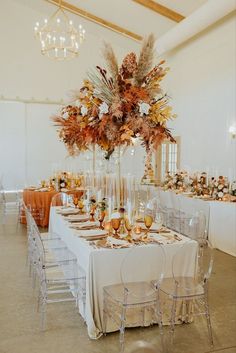 an elegant table set up with clear chairs