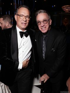 two men in tuxedos standing next to each other at a formal event together