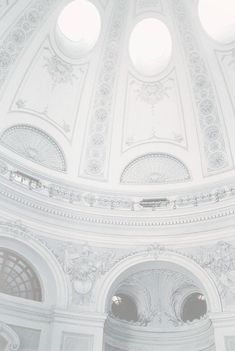 the interior of a large building with three round windows on each side and an arched ceiling