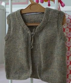 a knitted sweater hanging on a clothes rack in a child's room or bedroom