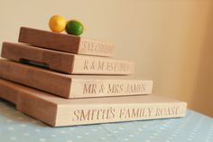 three wooden books stacked on top of each other with lemons and limes in the background