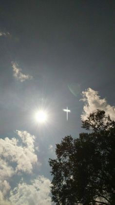 the sun shines brightly through the clouds as it passes over a cross in the sky