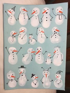 there are many snowmen on the blue paper