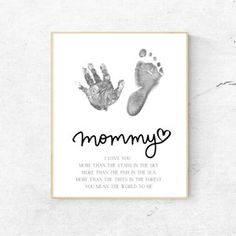 a hand and foot print with the words mommy written in black ink on white paper