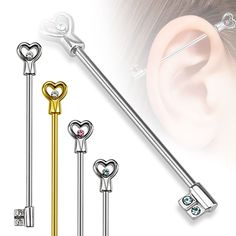 three pairs of surgical piercings with heart shaped keys and hearts on each end, one is