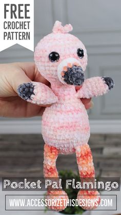 a small pink stuffed animal sitting on top of a wooden table with text overlay that reads free crochet pattern pocket pal flamingo