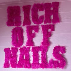 the words high off duty are written in bright pink fluffy letters on a white wall