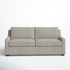 a gray couch sitting on top of a white floor