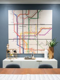 a dining room table with chairs and a map on the wall