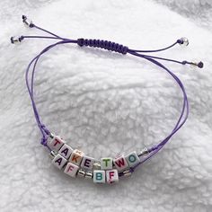 "BTS new song Take Two inspired Korean waxed thread friendship bracelet in purple with block letters spelling out \"Take Two\" and \"AFBF\" for Army Forever, Bangtan Forever.  Show your support for the new song, and your love for BTS.  Let's go for Take Two in 2025!  water resistent and wearable 24/7 if you like.  Spacer beads are of Czech clear iridescent glass 6/0 size seed beads.  Letter beads are 4mm in size.  The bracelet fits up to 9 inches around.  The length is adjustable with a sliding Bts Bracelet, Surprise Birthday Gifts, Bts New Song, Rear View Mirror Accessories, Block Letters, String Bag, Sliding Knot, Letter Beads, Plastic Resin