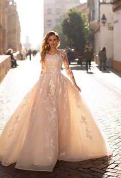 a woman in a wedding dress standing on the street