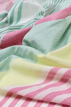 a close up view of a pink and green striped fabric