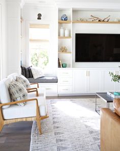 a living room filled with furniture and a flat screen tv