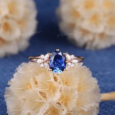 a blue ring sitting on top of a yellow flower