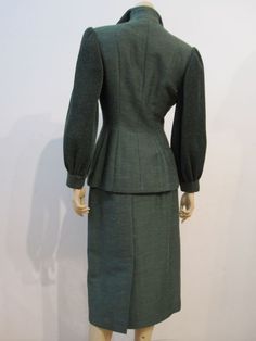 Lilli Ann 40s Silk moss-green suit.  The back view - the standup collar, full sleeves, soft shape of the jacket and longer skirt (with back kick vent) indicate that this suit carries influences from the 1930s - showing that the 40s haven't fully established themselves yet. Green Fitted Evening Suit, Classic Fitted Green Skirt Suit, Classic Green Fitted Skirt Suit, Elegant Fitted Lined Skirt Suit, Fitted Silk Skirt Suit For Work, Elegant Green Skirt Suit For Workwear, Green Fitted Skirt Suit For Formal Occasions, Chic Fitted Green Skirt Suit, Chic Green Fitted Skirt Suit