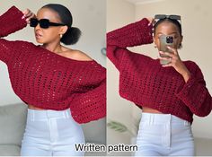 a woman taking a selfie while wearing a red crochet sweater and white pants