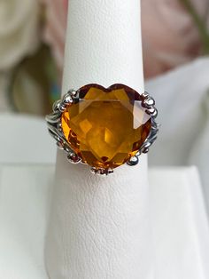 Yellow or Orange Heart Gem Sterling Silver RingHeart Leaf Design#D213 Our Silver Embrace Jewelry Heart Leaf Ring is a timeless and classic piece of Gothic inspired art. Crafted with beautiful filigree twists, this stunning ring features the perfect heart design, adorned with a magnificent 10ct-size simulated citrine - available in either orange or yellow to fit any palette. Enchanting and romantic, this exquisite handmade creation exudes vintage sophistication that can be adored for many years t Formal Handmade Orange Jewelry, Formal Orange Handmade Jewelry, Handmade Orange Formal Jewelry, Classic Orange Jewelry As Gift, Classic Orange Jewelry For Gift, Heirloom Orange Jewelry For Anniversary, Heirloom Orange Jewelry For Formal Occasions, Classic Orange Jewelry For Wedding, Orange Gemstone Jewelry For Wedding