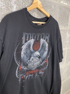 B Blaze Vintage offers this Vintage Y2K 2000s Biker Built Harley Davidson Black Motorcycle Graphic T-Shirt Harley Tag, Size XL Measurements upon request. All flaws will be pictured, see photos for condition. Please reach out for any questions! Follow us on Instagram! @BBlazeVintage Refund Policy No refunds will be granted due to dissatisfaction of how the items looks or fits. If there was a flaw in the item you feel that was missed, please reach out to us ASAP to find a solution. If you want mea 90s Black Top With Front Print, 90s Style Black Top With Front Print, Y2k Black Top With Front Print, Biker Style Screen Print Tops For Streetwear, Biker Style Tops With Screen Print For Streetwear, Biker Style Crew Neck Top With Logo Print, Biker Style Crew Neck Top With Screen Print, Black Biker Top With Screen Print, Biker Style Short Sleeve Tops With Graphic Print