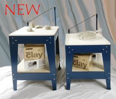 two blue and white side tables with newspaper on them, one is turned upside down