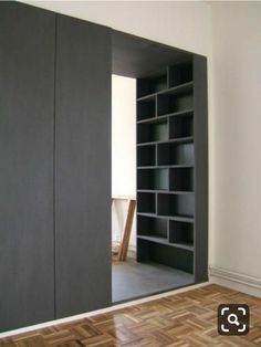 an empty room with some bookshelves in it