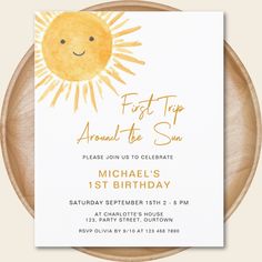 the first trip around the sun birthday party card is on a wooden plate with a white background