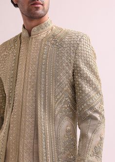 Exude sophistication and style with our regal beige sherwani set. A stunning juxtaposition of modernity and traditions. The double layered raw silk sherwani is elevated with intricate cutdana. And hand embellished zardozi work. Paired with a complementing kurta and pants. This ensemble will add a dash of royal flair. Dry-clean only if required. Slight variation in color is possible due to digital photography. Groom Pakistani Wedding Outfits, Men’s Wedding Outfits, Sharvani For Men Wedding, Sherwani Groom Wedding Royals, Indian Groom Wear Wedding, Mens Ethnic Wear Wedding, Sherwani For Men Wedding Indian Groom, Sherwani For Men Wedding Royals, Groom Sherwani Indian