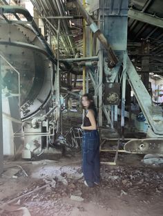 a woman standing in front of an industrial machine