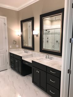 a large bathroom with double sinks and mirrors