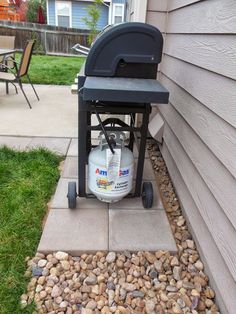 a gas tank sitting on the side of a house