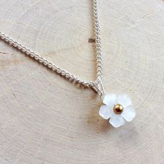 A Sweet, Delicate Flower Pendant. Made With A 14mm White Resin Flower, A 4mm Gold Glass Pearl, And Silver Plated Non-Tarnish Wire. The Flower Is Attached To The 18" Silver-Plated Curb Chain With A Handmade Triangle Bail. The Pendant Is Held Together By Nothing But Wire; No Glue Has Been Used. Not Intended For Children Under 12. Elegant White Birth Flower Necklace, Elegant White Flower Necklace With Birth Flower Detail, Elegant White Flower Necklace For Birthdays, Elegant White Flower Necklace For Birth Month, White Flower Pendant Necklace With Birth Flower, Dainty White Flower Pendant Necklace, White Birth Flower Pendant Necklace, White Dainty Flower Pendant Necklace, Minimalist White Flower Necklace