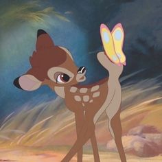 the fawn is holding a butterfly in her hand