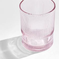 a pink glass sitting on top of a white table