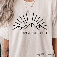 "Trust God & Chill- Christian Unisex Adult T Shirt, Inspirational Mountains Shirt, inspirational shirt, church church, religious t shirt This shirt is perfect for those who want to express their faith and love for God. The Bible verse on the front reads \"Trust in the Lord with all your heart and lean not on your own understanding; In all your ways acknowledge Him, and He will make your paths straight.\" This shirt is a great way to show your support for Christianity and remind yourself to trust in God every day.  The shirt is made of high quality materials and it's designed to be both stylish and comfortable. It's also a great birthday or Christmas gift for someone who loves Jesus Christ.Trust God & Chill- Christian Unisex Adult T Shirt, Inspirational Mountains Shirt This classic unisex j Wall Art Quotes Family, Mountains Shirt, Bible Study Gifts, Christian Graphic Tees, Faith Apparel, Scripture Shirt, Christian Affirmations, Bible Verses About Faith, Church Shirt