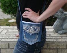 a woman with her back to the camera, wearing an old pair of blue jeans