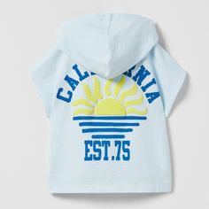 New "California" Embossed Hooded T-Shirt Sleeveless Tshirt With Hood. Front And Back Print With Raised Detail 9-12 Months Blue Hooded Tops For The Beach, Blue Hooded Tops For Beach, Blue Hooded Top For Beach, Blue Hooded Beach Tops, Hooded Beach Tops For Spring, White Hooded Tops For Summer, Hooded Beach Tops For Summer, Hooded Summer Beach Tops, Blue Hooded Cotton T-shirt