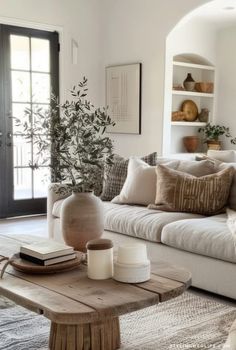 a living room filled with lots of furniture and decor on top of a rug covered floor