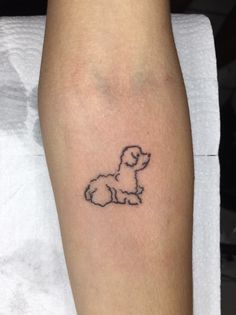 a small dog tattoo on the left leg and right leg is shown in black ink