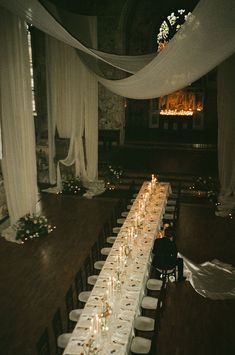 a long table is set up with candles