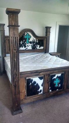 a wooden bed with cow hide on the headboard and foot board, made out of wood