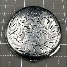 Pictured is a Vintage Birks Sterling Silver Powder Compact with Floral Design. The compact is 2 1/2" wide. Weighs 55.1 grams. Opens up with mirror on top portion no cracks in mirror, powder compact screen in place. Piece signed Birks Sterling Features: * Floral Condition: Pre-Owned Good There is one small dent as seen in pictures Vintage Compact Handmade Bag, Vintage Compact Makeup, Vintage Compact Mirror, Gold Compact Mirror Vintage, Vintage Powder Compacts, Piece Sign, Vanity Storage, Toiletry Storage, Womens Makeup