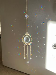 a white refrigerator freezer sitting next to a wall with beads and chains hanging from it's side