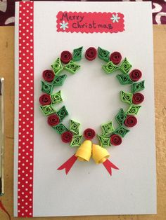 a christmas card made out of rolled up paper with red and green decorations on it