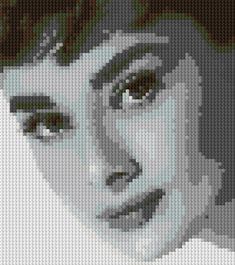 the face of a woman made out of legos is shown in grey and white