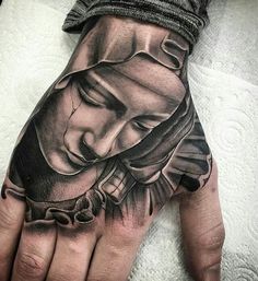 a person's hand with a tattoo on it