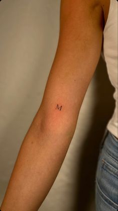 Arm Initial Tattoo, Initial Placement Tattoo, Maeve Tattoo, Minimalistic Initial Tattoo, Letter Arm Tattoo, Minimal Tattoo Initials, Initial M Tattoo, Cursive Initial Tattoo